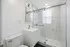 Sleek, modern bathroom featuring a glass-enclosed shower with elegant marble tiles, stylish vanity, and contemporary fixtures.
