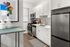 Contemporary kitchen with sleek appliances, elegant white cabinetry, and a modern backsplash, perfect for culinary creativity.