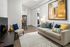 Chic living room with modern decor, cozy sectional sofa, vibrant artwork, and inviting open layout.