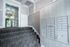 Modern apartment entryway with elegant stairs, sleek mailboxes, and glass door exuding contemporary charm.