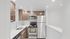 Sleek modern kitchen with stainless steel appliances, elegant wood cabinetry, and a stylish tiled backsplash.