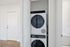 Modern apartment with sleek in-unit stacked washer and dryer conveniently tucked away in a closet.