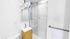 Sleek and modern bathroom with elegant marble tile, glass-enclosed shower, and stylish vanity with mirrored cabinet.