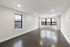 Bright and spacious living room with sleek hardwood floors and large windows providing abundant natural light.