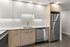 Modern kitchen with sleek stainless steel appliances, elegant white cabinetry, and a stylish subway tile backsplash.