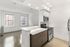 Contemporary, brightly lit kitchen with stainless steel appliances, sleek cabinetry, and open-plan layout.