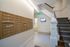 Elegant apartment hallway featuring secure mailboxes, inviting carpeted staircase, and modern lighting.