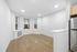 Bright, modern open living space featuring sleek hardwood floors, stylish recessed lighting, and a view of the vibrant city beyond.