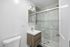 Sleek modern bathroom with a glass-enclosed shower and stylish vanity.