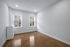 Bright and inviting room with sleek wooden floors, large windows, and fresh white walls, perfect for personalization.