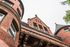Charming brick apartment building with elegant architectural details and turret design.