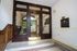 Charming apartment entrance with elegant wooden accents and classic tile flooring, offering a warm welcome.