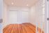 Inviting room with gleaming hardwood floors and elegant French doors, offering ample closet space and modern lighting.