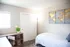 Nordica Flats, interior, bedroom, twin bed, window, desk, chair wall art