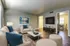 Inviting living room with sleek furniture, blue accents, and modern decor.