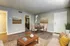 Inviting living room with a cozy sofa, elegant coffee table, and a quaint dining area in the corner.