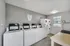 Bright and efficient laundry room with modern washers, dryers, and ample space.