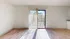 Bright and inviting living room with natural light, hardwood floors, and access to a balcony.