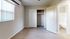 Bright bedroom with elegant wood flooring, spacious closet, and connected bathroom; perfect for modern living.