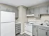 Chic modern kitchen with elegant grey cabinets, sleek countertops, and efficient appliances.