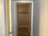 Spacious walk-in closet with elegant hardwood flooring, providing ample storage space for a modern apartment.