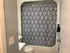 Chic bathroom featuring an elegant patterned shower curtain, modern fixtures, and calming neutral walls.