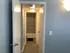 Inviting hallway view leading to a beautifully patterned bathroom, showcasing contemporary design and a warm ambiance.