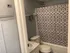 Charming bathroom featuring a patterned shower curtain, sleek fixtures, and contemporary design.