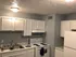 Charming modern kitchen with bright cabinetry, sleek appliances, and ample counter space.