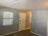Cozy apartment corner featuring soft lighting, neutral wall tones, and modern window blinds.