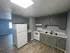 Modern kitchen with sleek gray cabinetry, spacious countertops, and elegant appliances, perfect for culinary creativity.