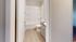 Sleek bathroom with modern fixtures, elegant wood flooring, and a pristine bathtub, offering comfort and style.