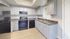 Contemporary kitchen with sleek appliances, elegant countertops, and spacious cabinetry, perfect for culinary enthusiasts.