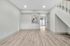 Bright and spacious open-concept living area with modern wood flooring and large sliding glass doors leading to a private patio.