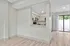 Modern kitchen with sleek cabinetry, granite countertops, and bright open layout leading to a private patio.