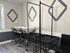 Modern laundry area with sleek black rolling carts and elegant wall decor, enhancing functionality and style.