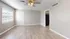 Bright and airy apartment living space featuring modern vinyl flooring, a ceiling fan, and ample natural light from the large window.
