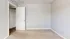 Bright, empty room with soft beige carpet and crisp white walls, ideal for customizing your dream space.