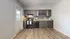 Chic kitchen with modern dark cabinetry, sleek countertops, and stylish backsplash, ideal for culinary creativity.