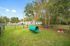 Inviting pet-friendly green space with a playful tunnel feature, enclosed for safety and convenience, perfect for relaxation and outdoor fun.