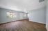Bright and inviting living area with large windows and elegant wood flooring, perfect for relaxation and entertaining.