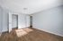 Bright and spacious bedroom featuring elegant wooden flooring and ample natural light, perfect for a cozy and modern retreat.