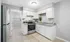 Modern kitchen with sleek stainless steel appliances, elegant white cabinetry, and stylish granite countertops.