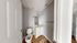 Charming bathroom with modern fixtures, stylish vanity, and sleek wood flooring, maximizing space and comfort.