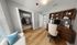 Elegant home office setup with warm wooden desk, stylish shelving, and cozy seating, perfect for productivity and comfort.