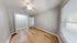 Bright and cozy bedroom with elegant wooden flooring, a spacious closet, and large windows offering ample natural light.
