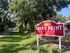 Welcome to Sunny Point Apartments nestled in lush greenery, offering a serene and inviting atmosphere.