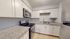 Chic modern kitchen with sleek granite countertops, stainless steel appliances, and ample white cabinetry for a stylish cooking space.