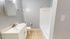 Bright and clean bathroom featuring a modern sink, toilet, and a pristine bathtub, optimized for comfort and style.