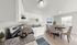 Modern kitchen and dining area featuring sleek appliances, elegant dining table, and ample natural light.